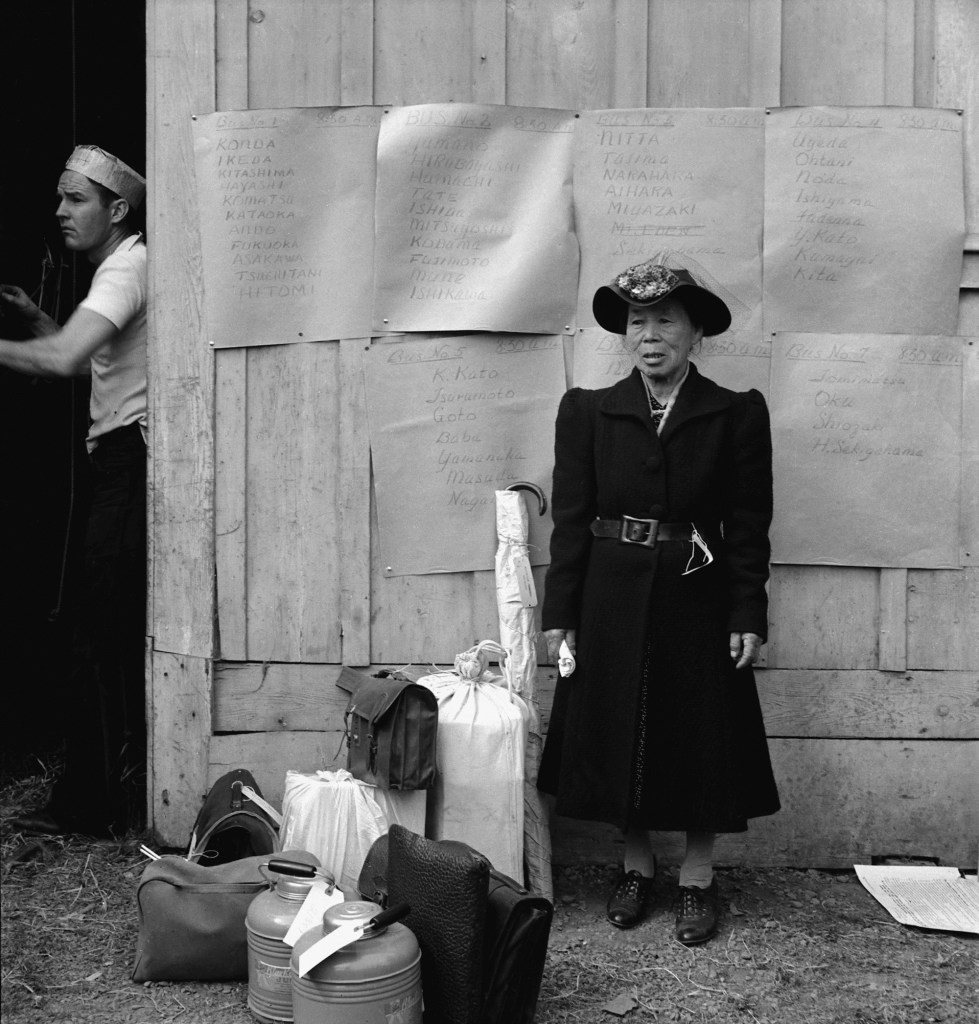 Dorothea Lange (American, 1895-1965) 'Centerville, California. This evacuee stands by her baggage as she waits for evacuation bus' 1942 Dorothea Lange (American, 1895-1965) 'Centerville, California. This evacuee stands by her baggage as she waits for evacuation bus' 1942