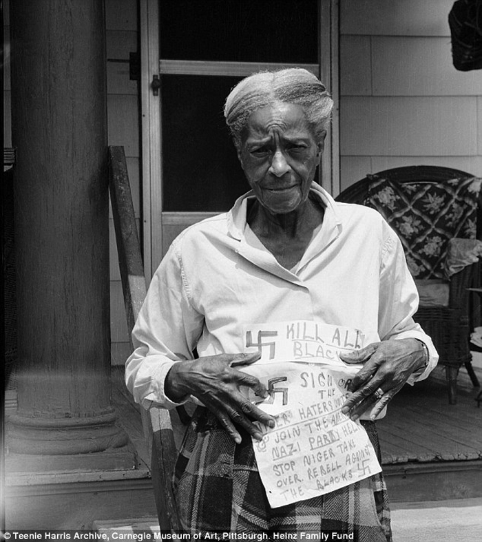 Charles "Teenie" Harris (American, 1908-1998) 'Mary Reid holding threatening notes with swastikas and American Nazi Party propaganda, in July 1964' 1964