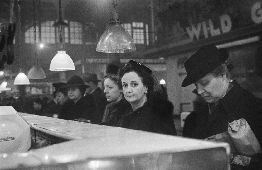 Roman Vishniac (1897-1990) 'Customers waiting in line at a butcher's counter during wartime rationing, Washington Market, New York' 1941-1944