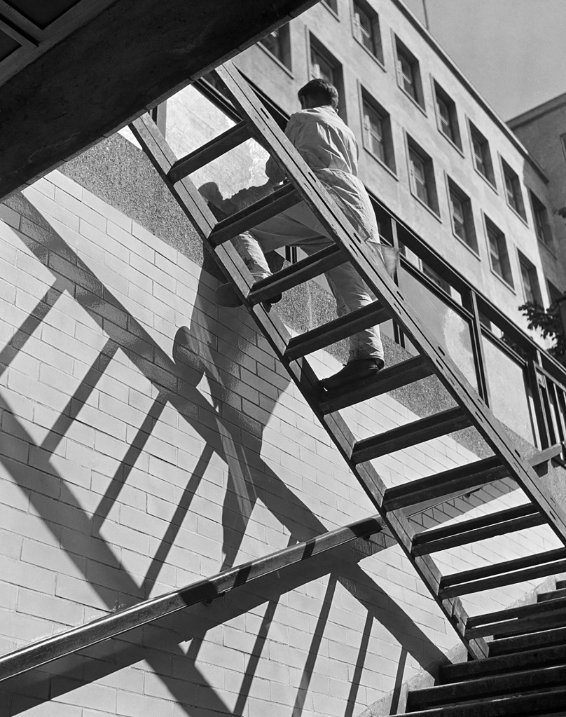Roman Vishniac (America born Russia, 1897-1990) 'Window washer balancing on a ladder, Berlin' mid-1930s