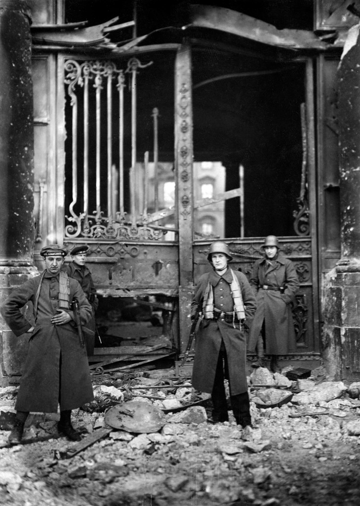 Willy Römer (German, 1887-1979) 'Street battles on Christmas Eve in Berlin. Naval ratings in front of the ruined Palace entrance after bombardment by artillery' 24.12.1918