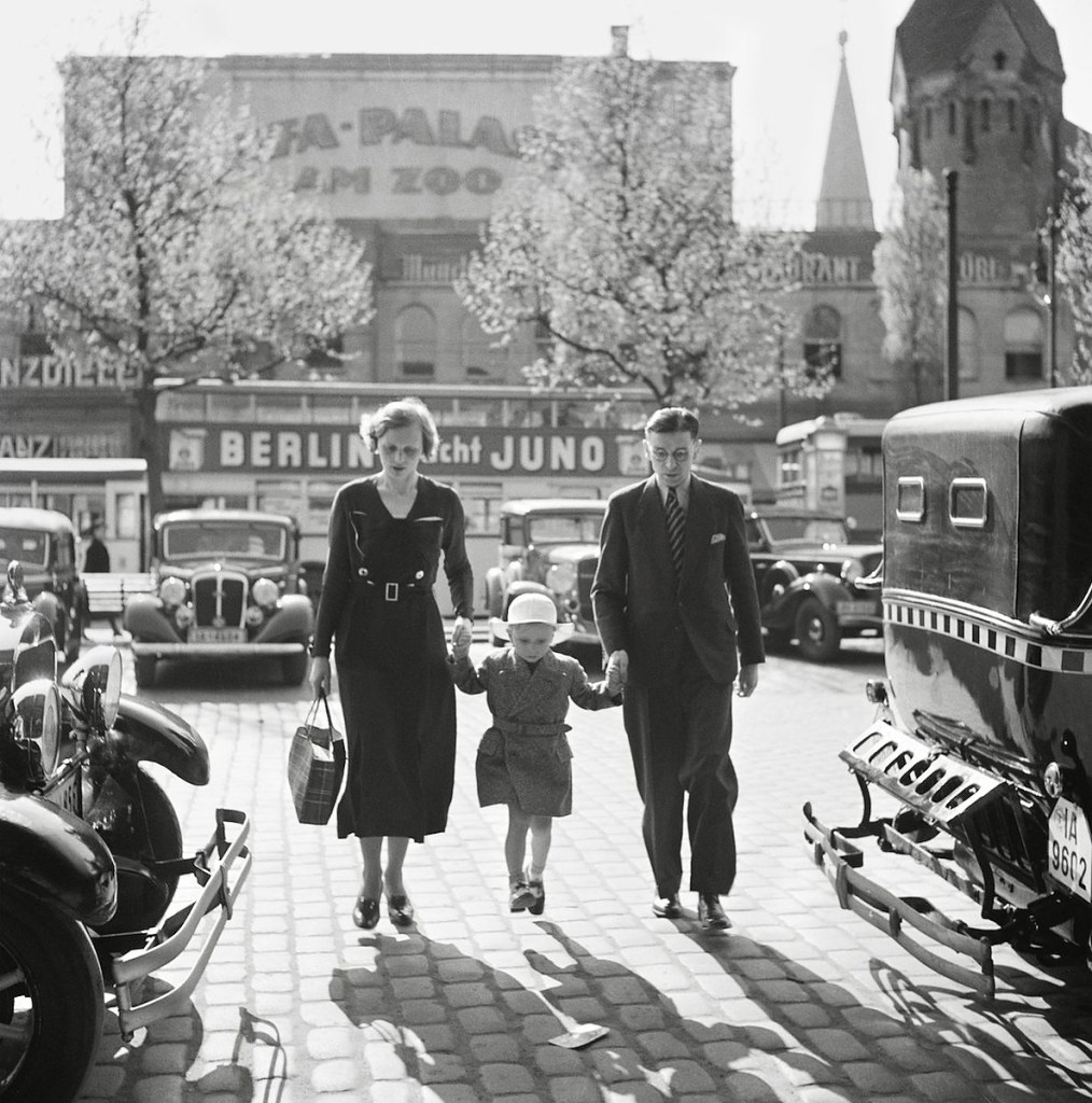 Roman Vishniac (America born Russia, 1897-1990) 'German family walking between taxicabs in front of the Ufa-Palast movie theater, Berlin' late 1920s-early 1930s from the exhibition Exhibition: 'Roman Vishniac Rediscovered' at The Photographers' Gallery and Jewish Museum London, Oct 2018 - Feb 2019