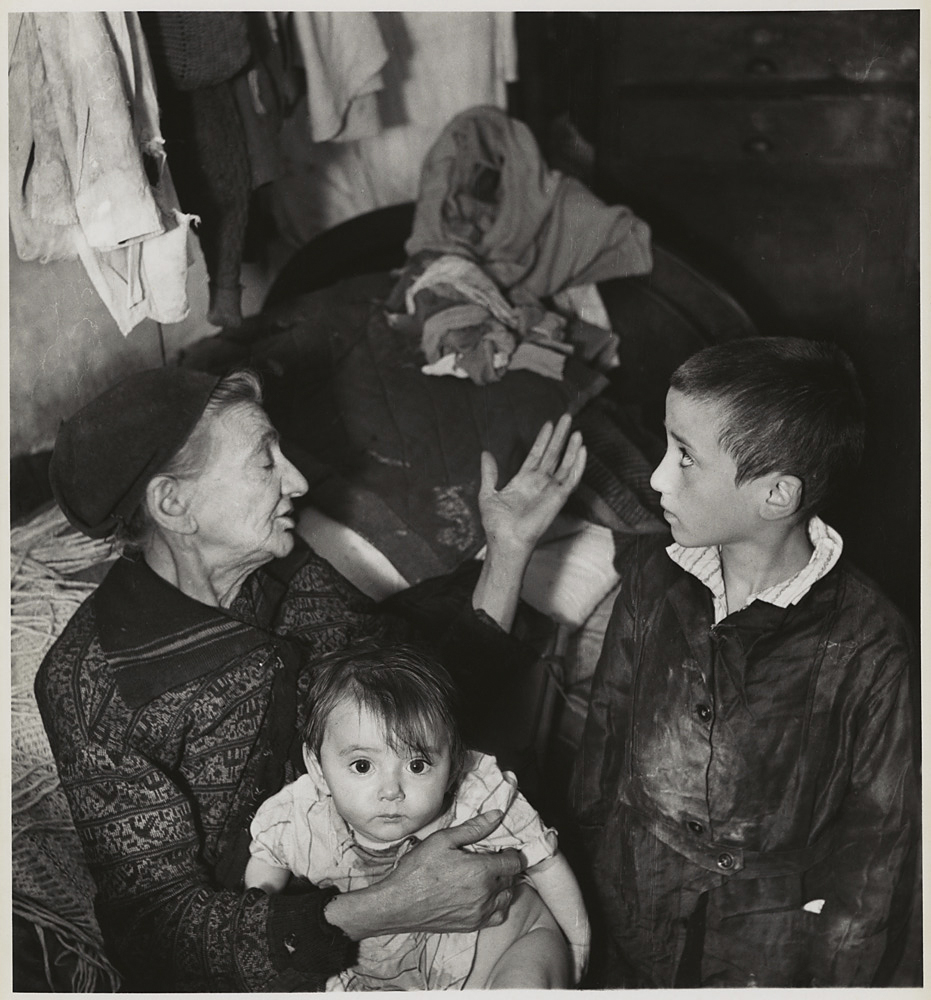 Roman Vishniac (America born Russia, 1897-1990) '[Grandmother and grandchildren in basement dwelling, Krochmaina Street, Warsaw]' c. 1935-1938