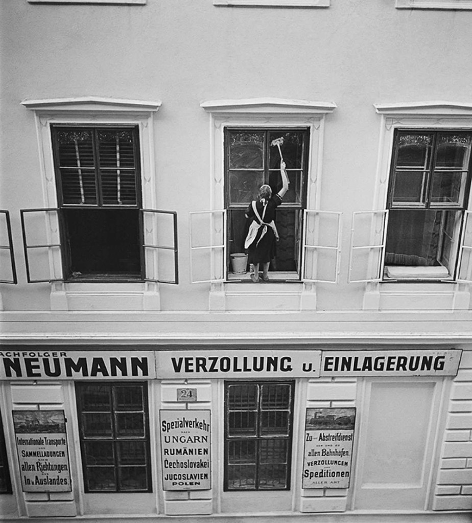 Roman Vishniac (America born Russia, 1897-1990) 'Woman washing windows above Mandtler & Neumann Speditionen (Mandtler & Neumann Forwarding Agents), Ferdinandstrasse, Leopoldstadt, Vienna' 1930s
