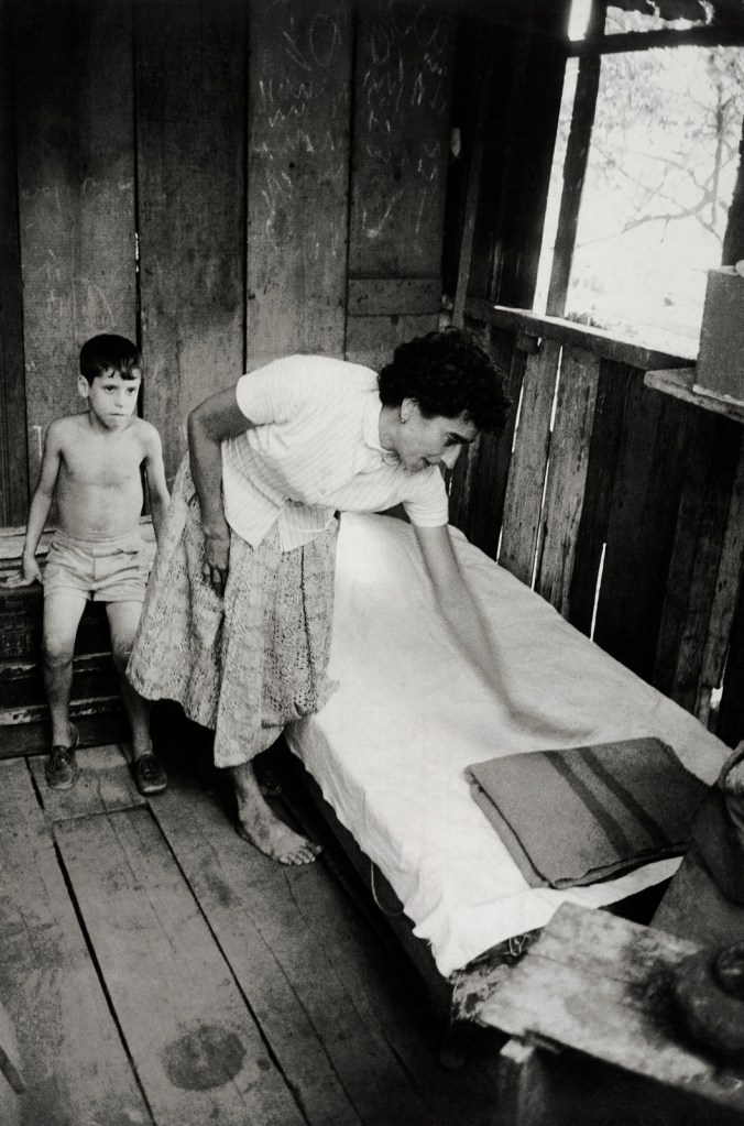 Henri Ballot (French / Brazilian, 1921-1997) 'Aracy, a Neighbour of the da Silva Family, Pointing out Where the Photographs for Gordon Parks's Reportage Were Taken in the da Silvas' Former Home, Catacumba Hill, Rio de Janeiro, Brazil' 1961