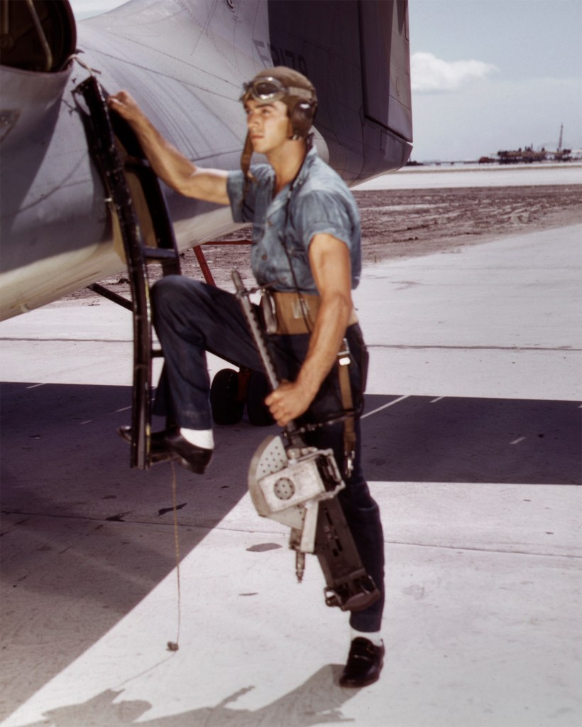 Howard R. Hollem (American, d. 1949) for the United States Office of War Information. 'Jesse Rhodes Waller, a World War II Aviation Ordnanceman stationed at the Naval Air Station in Corpus Christi, Texas, installing a M1919 Browning machine gun in a United States Navy PBY plane' (detail) August 1942