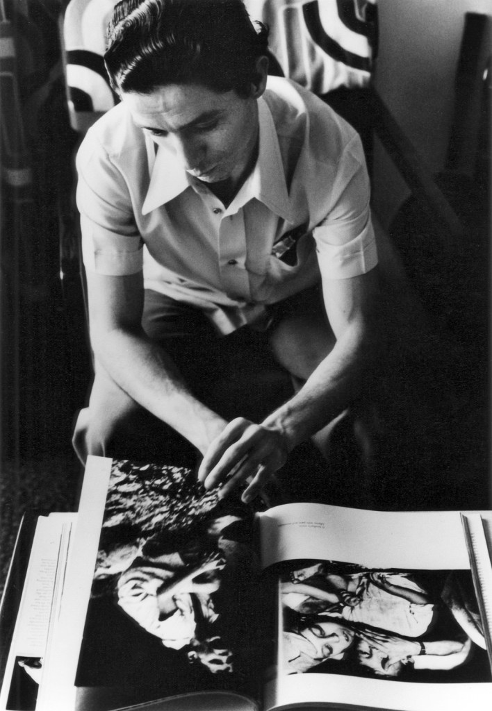 Gordon Parks (American, 1912-2006) 'Flávio da Silva Looking at Gordon Parks's Book 'Moments Without Proper Names', Rio de Janeiro, Brazil' 1976