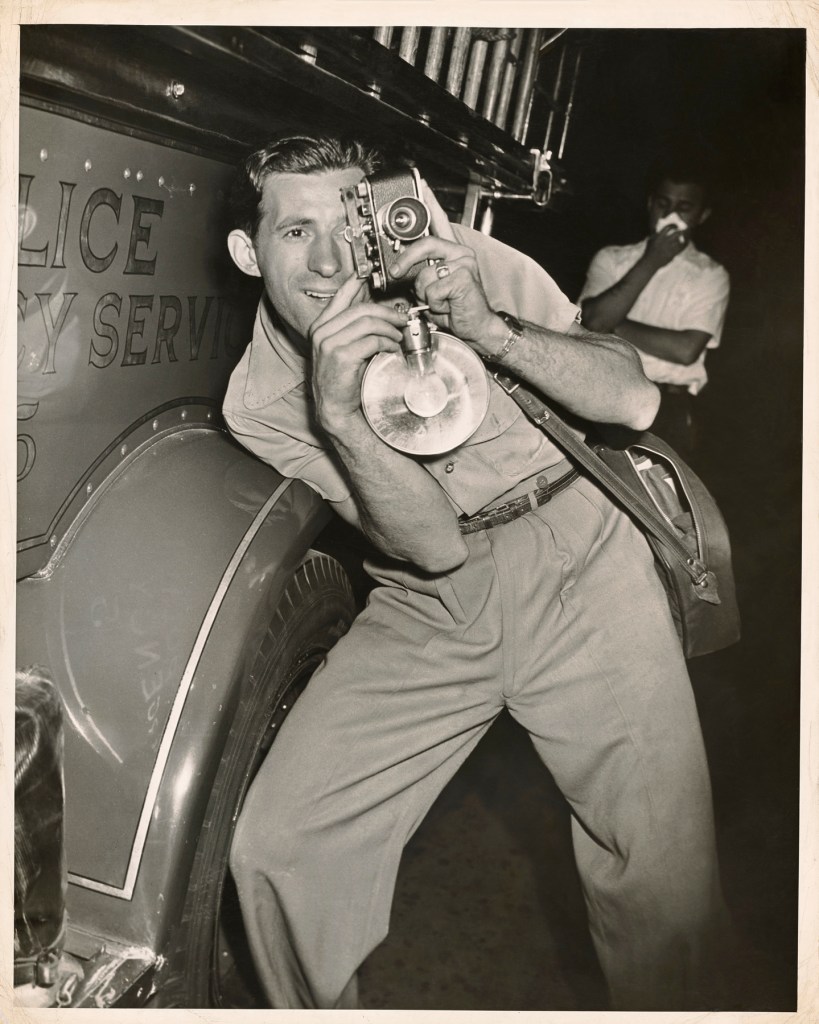 Weegee (Arthur Fellig) (American, born Austria, 1899-1968) 'Photographer at a Fire' 1940-1945