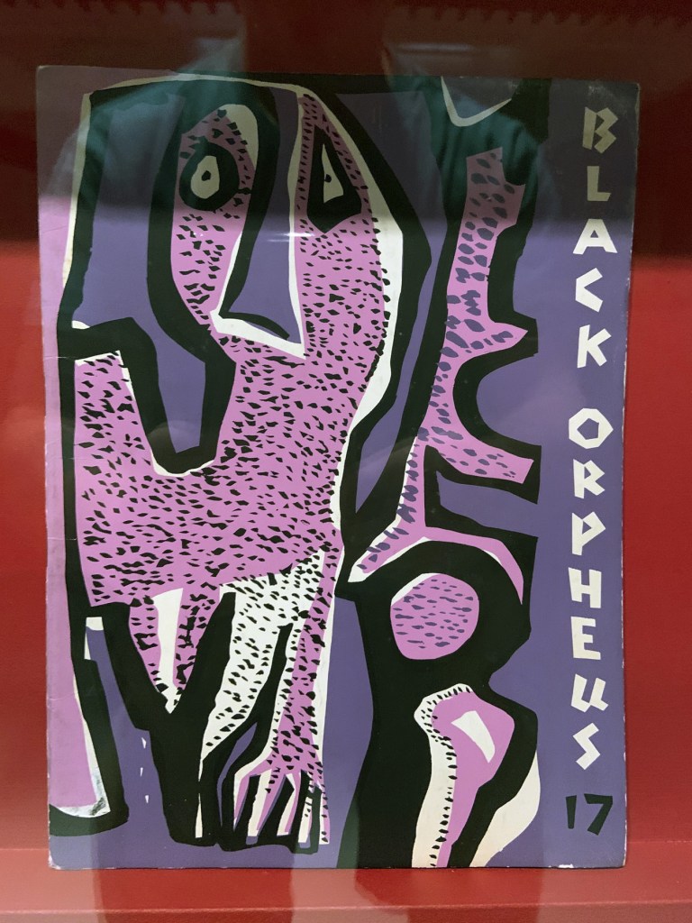 Installation view of the exhibition 'Into the Night: Cabarets and Clubs in Modern Art' at the Barbican Art Gallery showing some of the publishing output of the Mbari clubs Installation view of the exhibition 'Into the Night: Cabarets and Clubs in Modern Art' at the Barbican Art Gallery showing some of the publishing output of the Mbari clubs