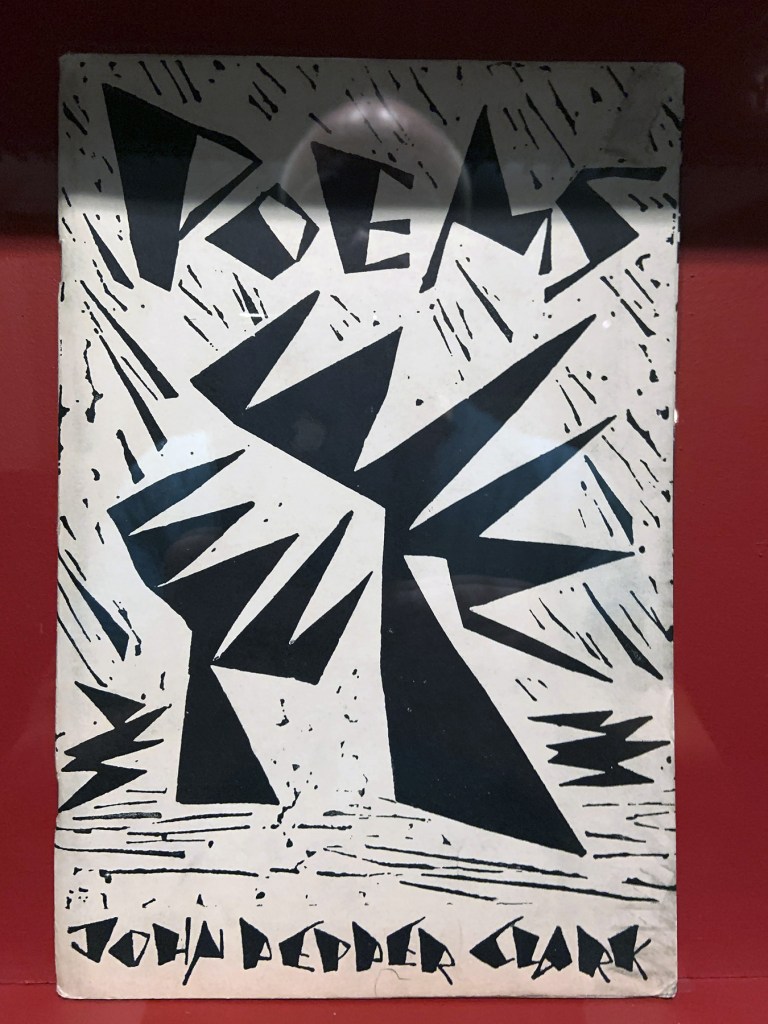 Installation view of the exhibition 'Into the Night: Cabarets and Clubs in Modern Art' at the Barbican Art Gallery showing some of the publishing output of the Mbari clubs Installation view of the exhibition 'Into the Night: Cabarets and Clubs in Modern Art' at the Barbican Art Gallery showing some of the publishing output of the Mbari clubs