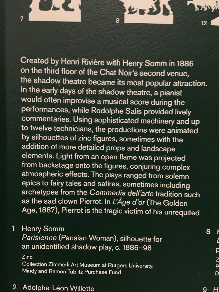 Installation view of the exhibition 'Into the Night: Cabarets and Clubs in Modern Art' at the Barbican Art Gallery, London showing Henri Rivière and Henry Somm's shadow theatre wall text Installation view of the exhibition 'Into the Night: Cabarets and Clubs in Modern Art' at the Barbican Art Gallery, London showing Henri Rivière and Henry Somm's shadow theatre wall text