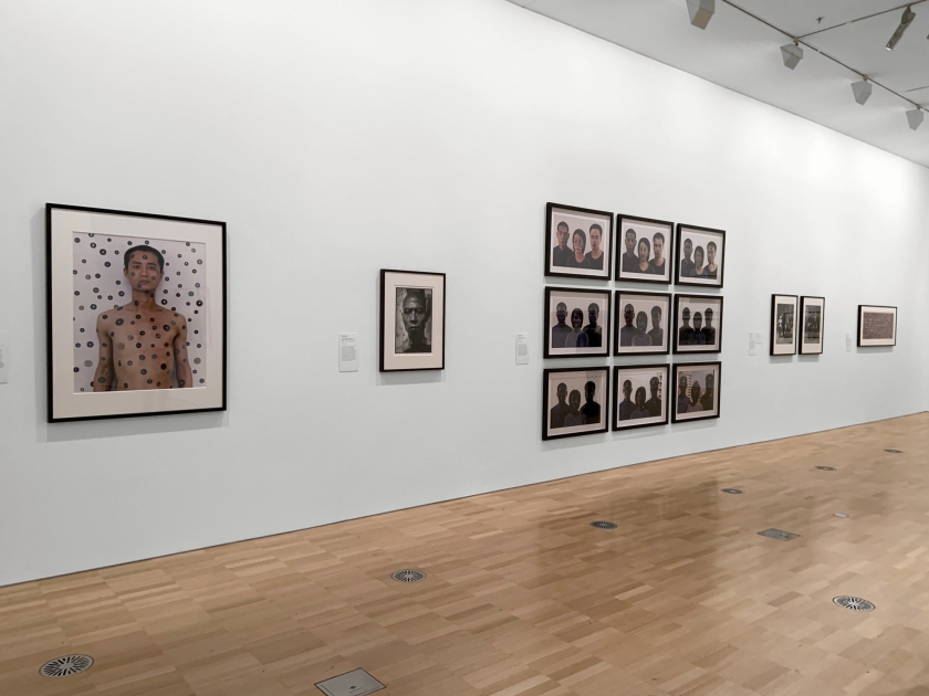 Installation view of the exhibition 'Turning Points: Contemporary Photography from China' at the National Gallery of Victoria, Melbourne showing at left, Qiu Zhijie (Chinese, b. 1969) 'Tattoo no. 7' (1994); at second left, Rong Rong (Chinese, b. 1968) 'East Village Beijing no. 15' (1994); and at middle right, Zhang Huan (Chinese, b. 1965) 'Shanghai family tree' (2001)