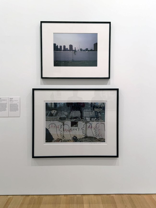 Installation view of the exhibition 'Turning Points: Contemporary Photography from China' at the National Gallery of Victoria, Melbourne showing at top, Weng Fen's 'On the wall: Guangzhou (4)' (2002) and at bottom, Zhang Dali's '2001 42A' (2001)