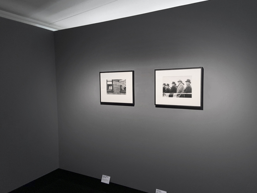 Installation view of the exhibition Robert Frank. Unseen at C/O Berlin showing at left, 'Parade – Hoboken, New Jersey' (1955) and at right, 'City Fathers – Hoboken, New Jersey' (1955)