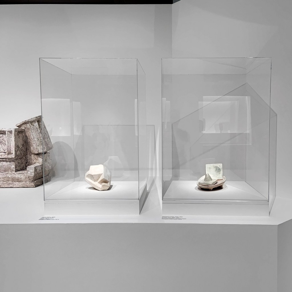 Installation view of the exhibition 'Alberto Giacometti' at the Trade Fair Palace, National Gallery Prague showing at left in the top photograph, 'Cubist figures / couples', and at right in the bottom photograph, 'Pocket-Tray' 1930-1931