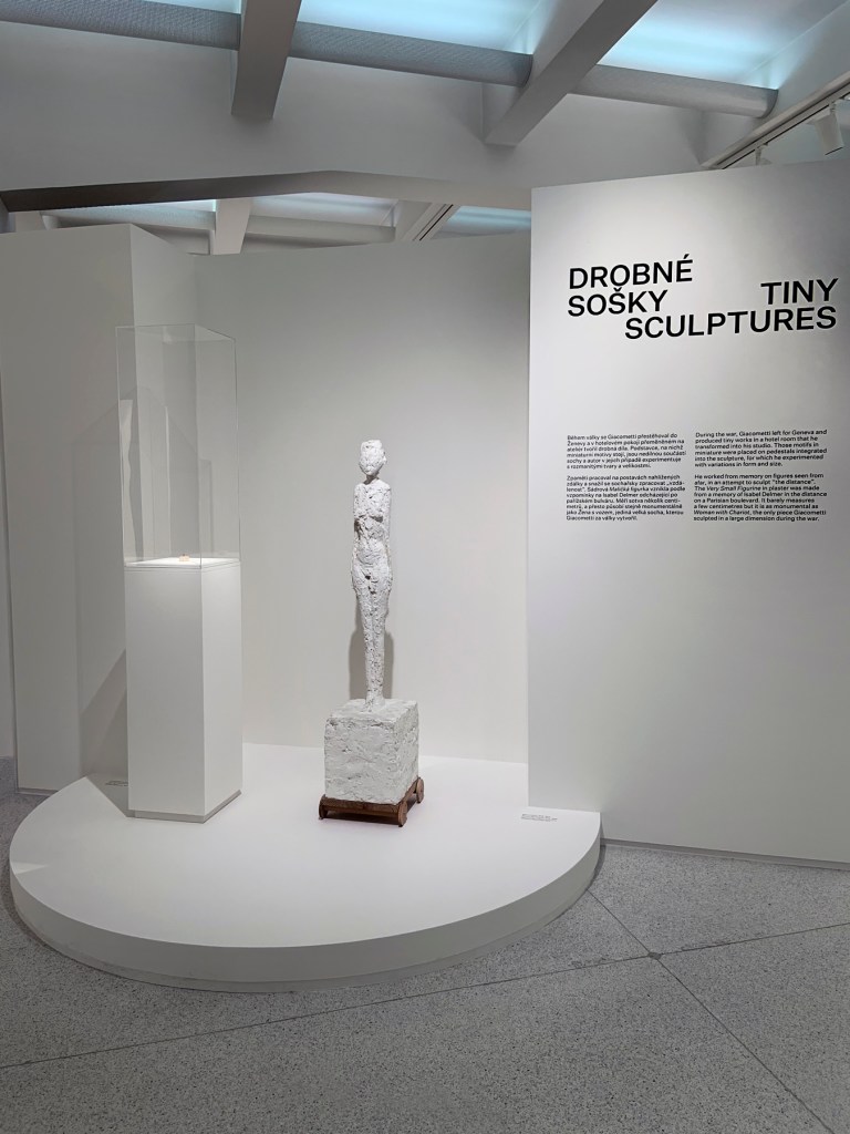 Installation view of the exhibition 'Alberto Giacometti' at the Trade Fair Palace, National Gallery Prague showing at left 'Very Small Figurine' (1937-1939), and at right 'Woman with Chariot' (1943-1945) (installation view)
