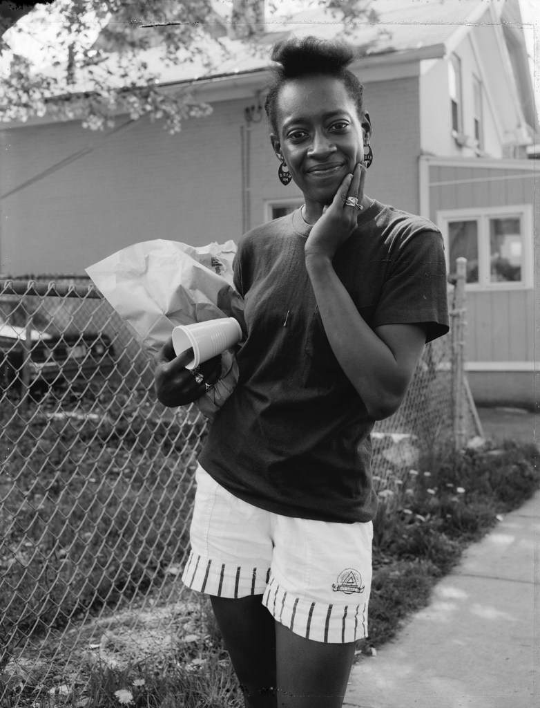 Dawoud Bey (American, b. 1953) 'A Young Woman Coming from the Store, Rochester, NY 1989' 1989