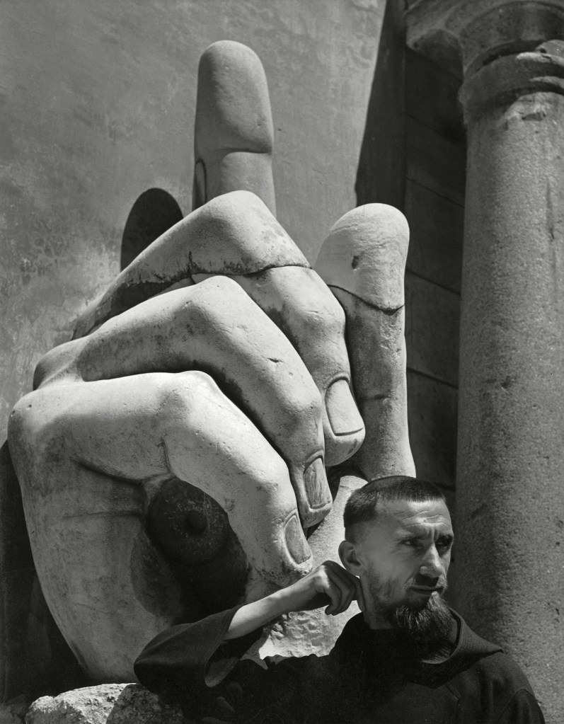 Herbert List (German, 1903-1975) 'Finger of God - Capuchin Monk in front of a fragment of the Statua Colossale di Costantino, Italy, Rome' 1949