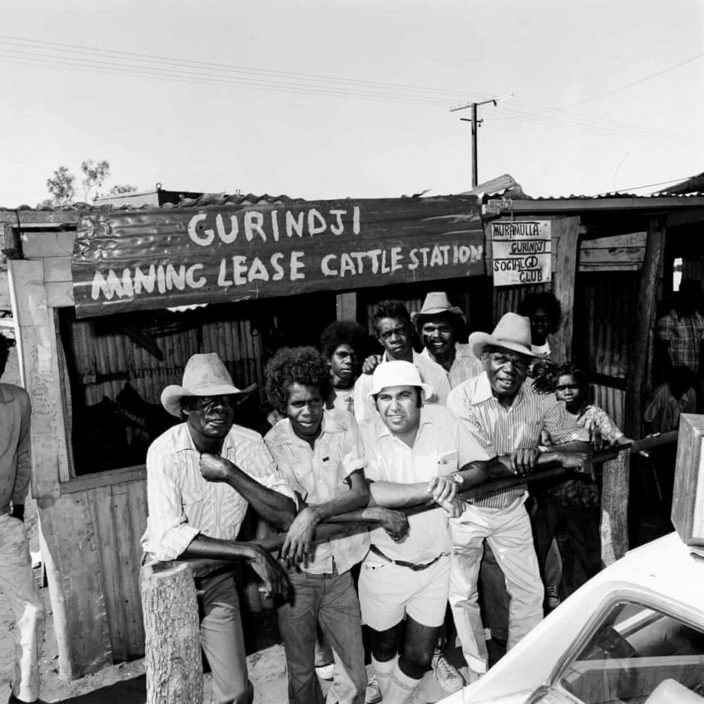 Mervyn Bishop (Australian, b. 1945) 'Bishop and Gurindji men outside the Murramulla Social Club' 1975