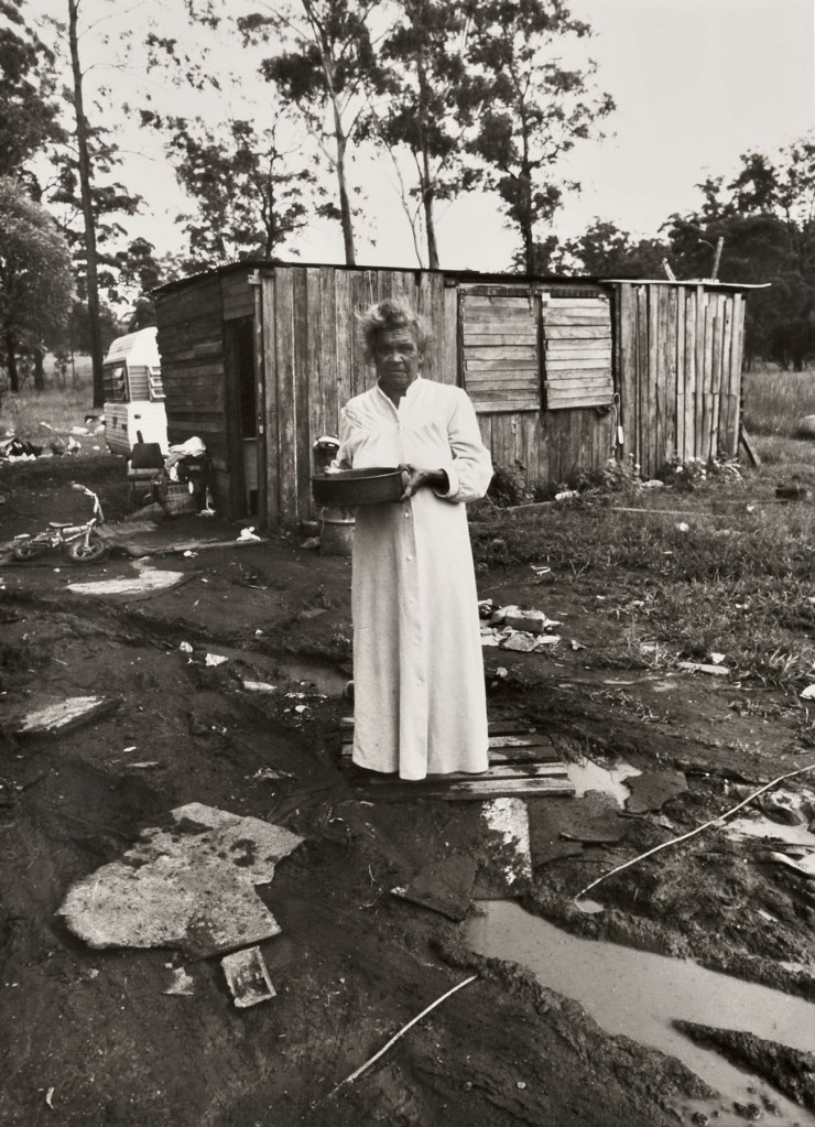 Mervyn Bishop (Australian, b. 1945) 'Woman standing near electric power cord in water, Burnt Bridge' 1988, printed 2008