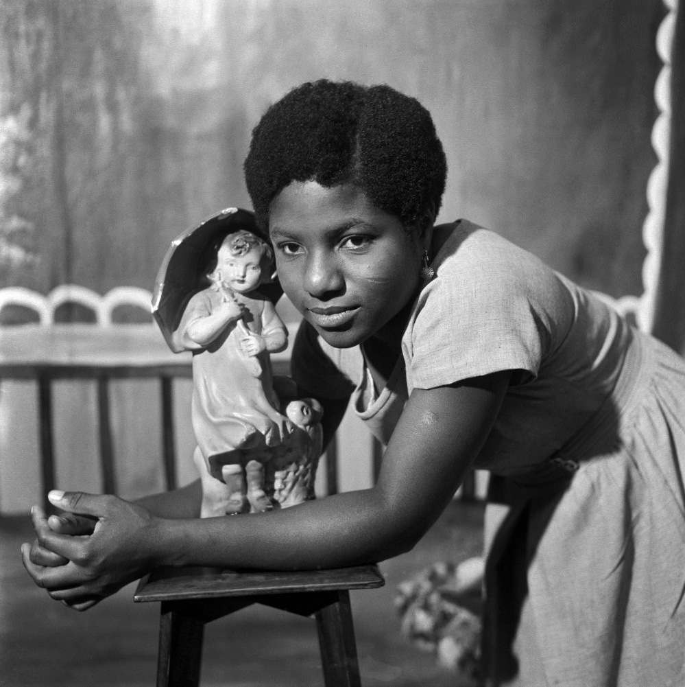 James Barnor (Ghanian, b. 1929) 'Beatrice with trademark figurine, Ever Young Studio, Accra' c. 1953
