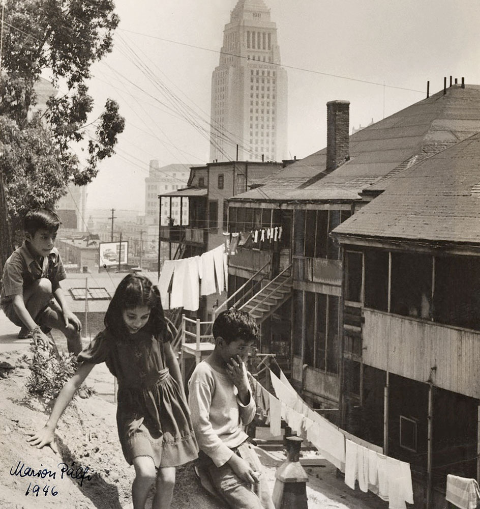 Marion Palfi (American born Germany, 1907-1978) 'Three children playing behind houses in Boyle Heights' 1946