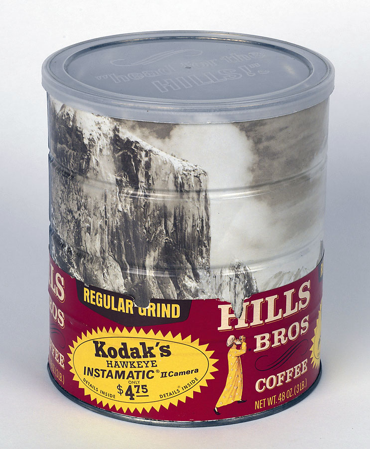 Ansel Adams / Hills Brothers coffee can 1969. Hills Brothers coffee can, with a wraparound image of Adams' Winter Morning, Yosemite Valley; this can with the rare original red and yellow "belly band" specifying the grind and date, and advertising a Kodak Instamatic II camera on special offer for only $4.75.