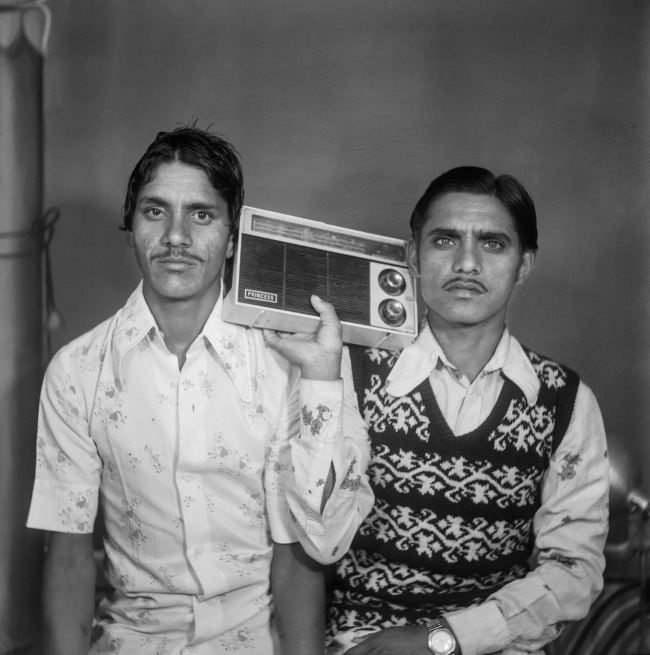 Suresh Punjabi (Indian, b. 1957) 'Untitled (Two men with a transistor radio), Suhag Studio, Nagda, Madhya Pradesh' 1983