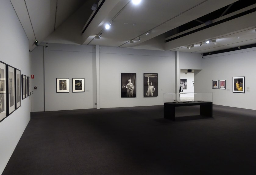 Installation view of the exhibition 'Visions of India: from the colonial to the contemporary' at the Monash Gallery of Art showing at centre, two photographs by Gauri Gill (see below)