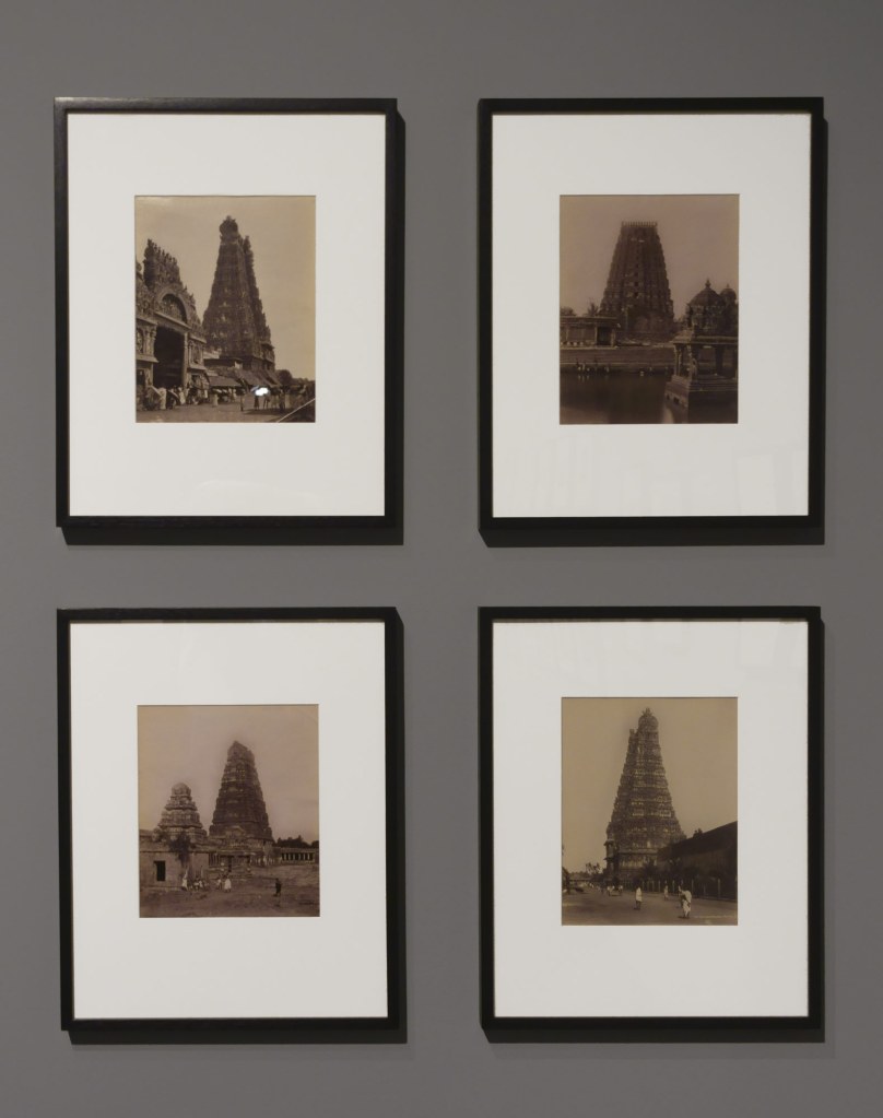 Installation view of the exhibition 'Visions of India: from the colonial to the contemporary' at the Monash Gallery of Art showing showing at top left, Nicholas & Company (attributed). 'Meenakshi Temple, Madurai' (c. 1880, below); at top right, Nicholas & Company (attributed). 'Sacred tank' (c. 1860); at bottom left, Nicholas & Company (attributed). 'Temple, Madurai' (c. 1880); and at bottom right, Wiele and Klein Studio. 'The Southern Gopura, Meenakshi Temple, Madurai' (1895)