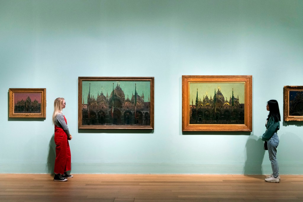 Installation view of the exhibition 'Walter Sickert' at Tate Britain, May - September 2022 showing at second left, 'The Façade of San Marco, Venice' 1896-1897; and at second right, 'St Mark's, Venice' 1896