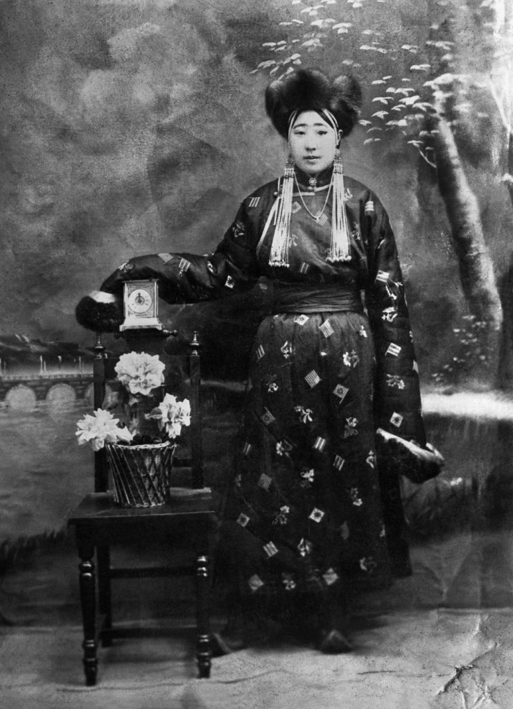 Unknown photographer. 'Untitled [Mongolian woman with clock and flowers]' 1910s-1920s