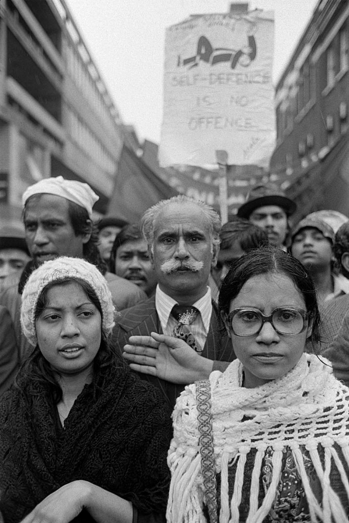 Paul Trevor (British, b. 1947) 'Adler Street, London E1, 14 May 1978. The start of the march behind Altab Ali's coffin from Whitechapel to Hyde Park, organised by the Action Committee Against Racial Attack' 1978 from the exhibition 'Brick Lane 1978: The Turning Point' at Four Corners, London, June - Sept, 2022