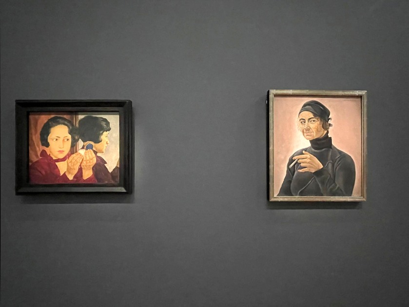 Installation view of the exhibition 'Germany / 1920s / New Objectivity / August Sander' at Centre Pompidou, Paris showing at left, Lotte Laserstein's 'Russian Girl with Compact' (1928); and at right, Rudolf Schlichter's 'Margot' (1924)