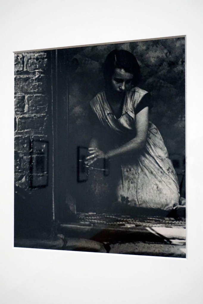 Installation view of the exhibition 'Bill Brandt: Inside the Mirror' at Tate Britain, London, October 2022 - January 2023 showing Brandt's photograph 'Housewife, Bethnal Green' (1937)