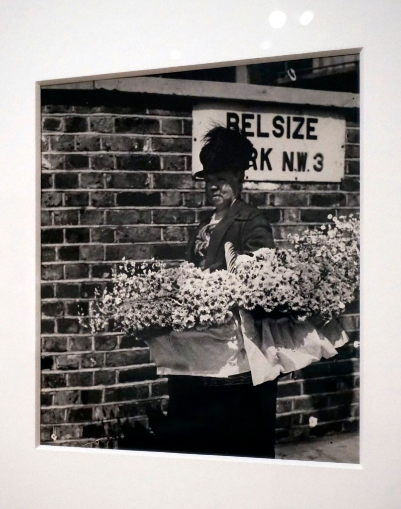 Installation view of the exhibition 'Bill Brandt: Inside the Mirror' at Tate Britain, London, October 2022 - January 2023 showing Brandt's photograph 'Flowerseller in Hampstead, All a blowin' and a growin'' (1936)