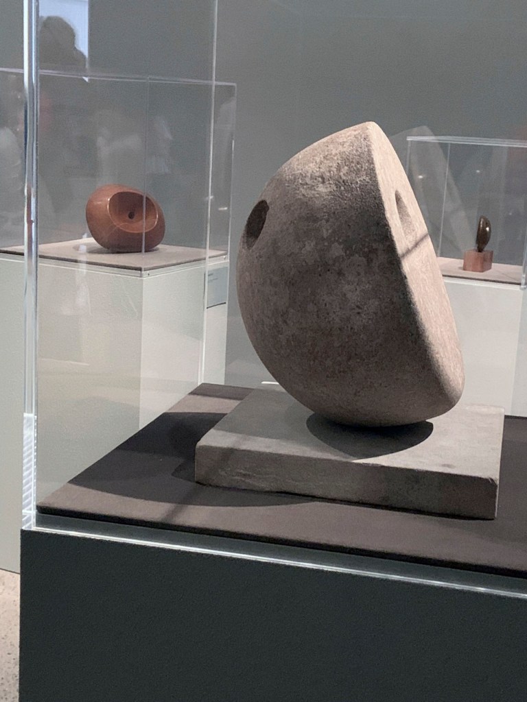 Installation view of the exhibition 'Barbara Hepworth: In Equilibrium' at the Heide Museum of Modern Art, Melbourne showing at front 'Pierced Hemisphere II' 1937-1938; at background left 'Conicoid' 1937; and at background right 'Pierced Round Form' 1959-1960