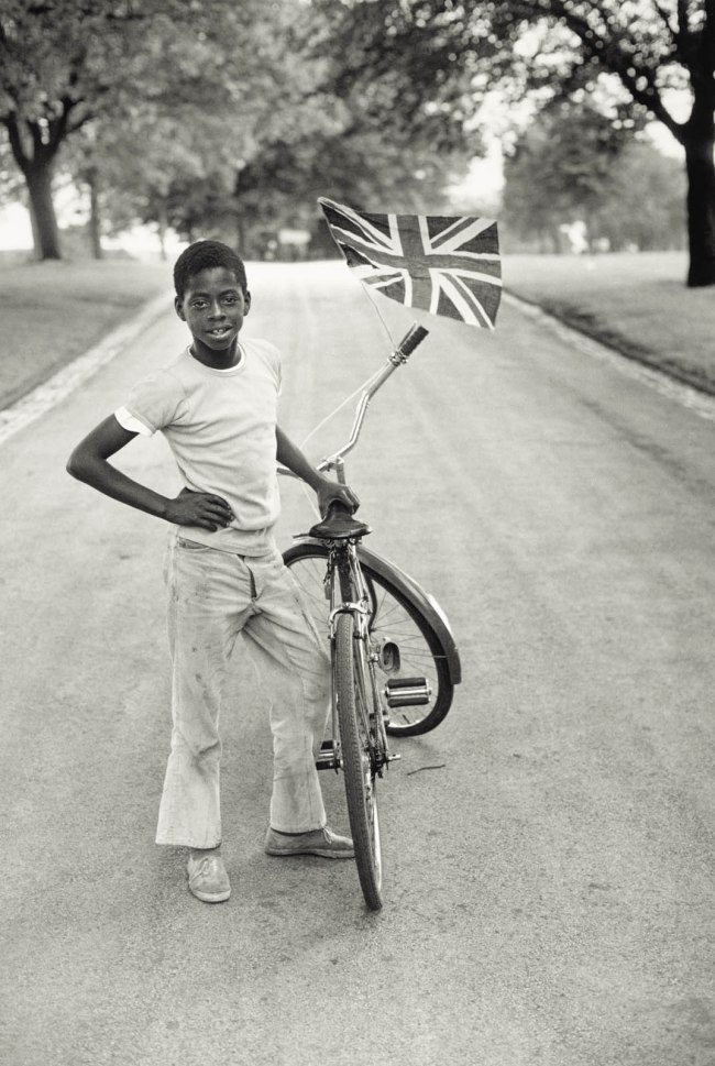 Vanley Burke (British born Jamaica, b. 1951) 'Boy with Flag, Winford in Handsworth Park' 1970, printed 2022