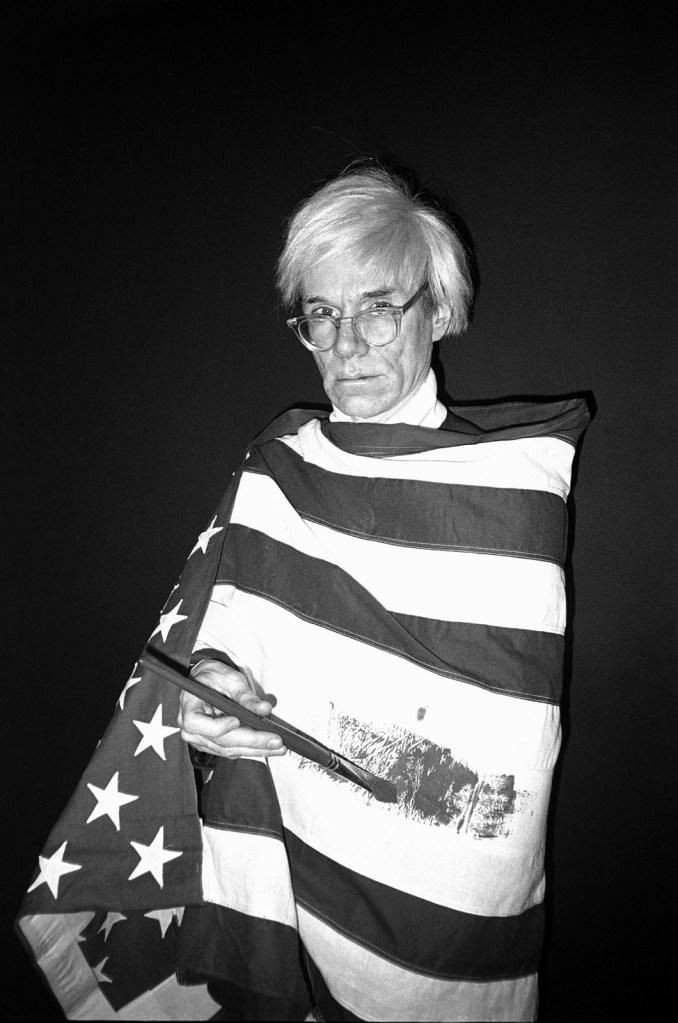 Christopher Makos (American, b. 1948) 'Andy Warhol in American flag, Madrid' 1983