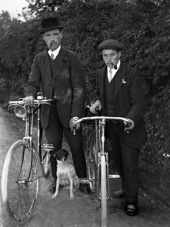 Richard Jenkins (British, 1890-1964) 'Untitled [Two men with pipes, bicycles and dog]' Nd