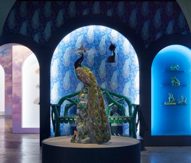 Installation view of the exhibition '1,001 Remarkable Objects' at Powerhouse Ultimo, Sydney showing in the foreground, Figure, 'Peacock', earthenware with majolica glazes, modelled by Paul Comolera, made by Mintons, Stoke-on-Trent, Staffordshire, England, c. 1873-1875