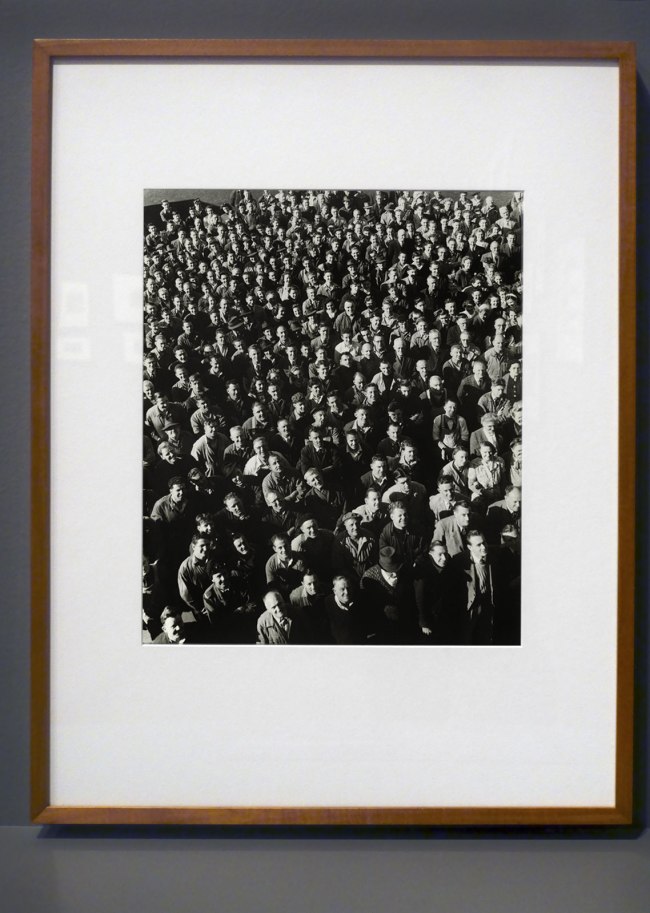 Installation view of the exhibition Photography: Real & Imagined at The Ian Potter Centre: NGV Australia, Melbourne showing Wolfgang Sievers' 'Shiftchange at Kelly and Lewis engineering works, Springvale, Melbourne' (1949)