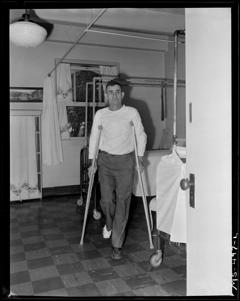 Russell Lee (American, 1903-1986) 'Telesfro Deluna, miner, walking on crutches. He is recovering from a foot injury in mine a accident. He has received medical care at this company owned hospital. Colorado Fuel & Iron Company, Pueblo, Colorado' July 1, 1946