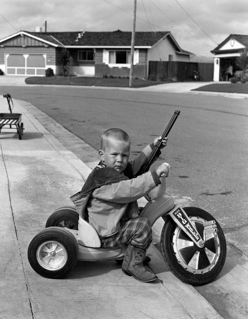 Bill Owens (American, b. 1938) 'I don't feel that Richie playing with guns will have a negative effect on his personality. (He already wants to be a policeman.)' 1972