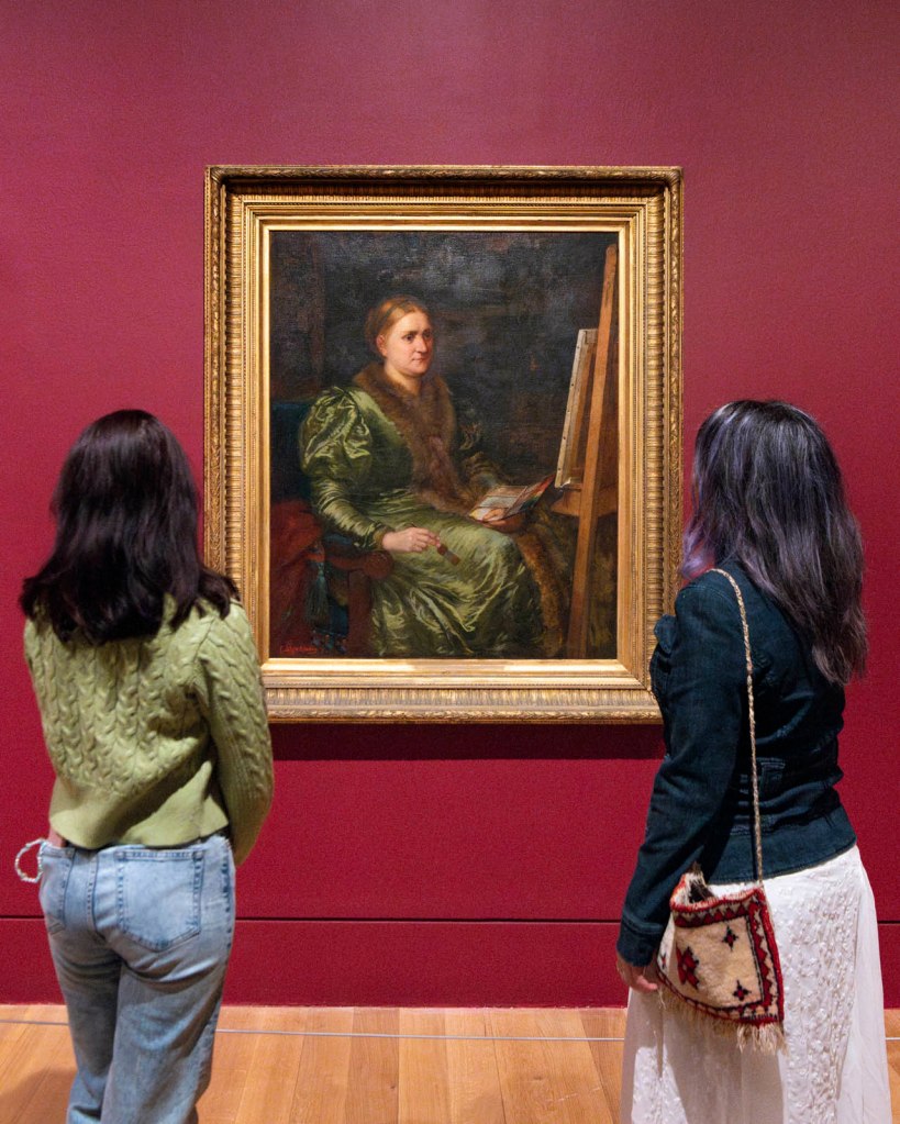 Installation view of the exhibition 'Now You See Us Women Artists in Britain 1520-1920' at Tate Britain showing Emily Mary Osborn's 'Barbara Bodichon (1827-1891)' Nd (below)