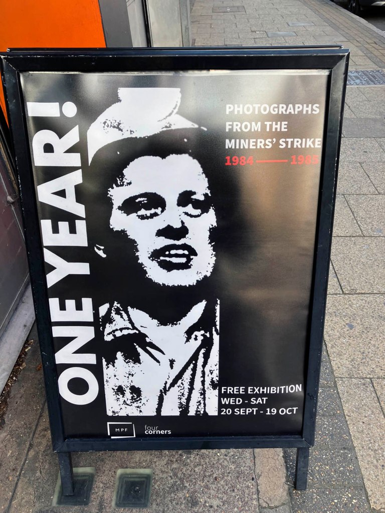 Poster for the exhibition 'ONE YEAR! Photographs from the Miners' Strike 1984-85' outside of Four Corners, London