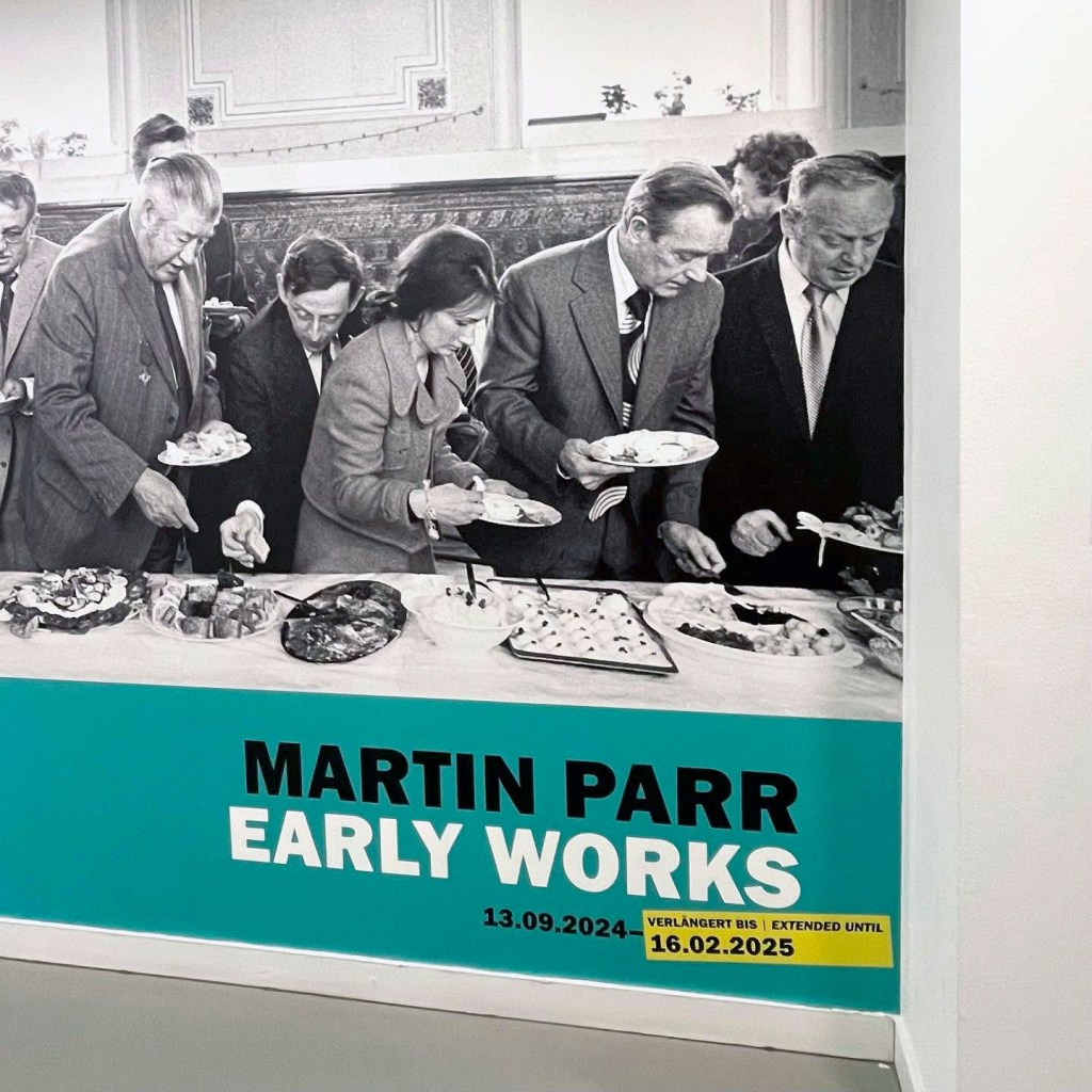 Installation view of the exhibition 'Martin Parr. Early Works' at Fotografie Forum Frankfurt (FFF) showing an enlargement of Parr's photograph 'Mayor of Todmorden's inaugural banquet, Todmorden, West Yorkshire, England, 1977' (detail)