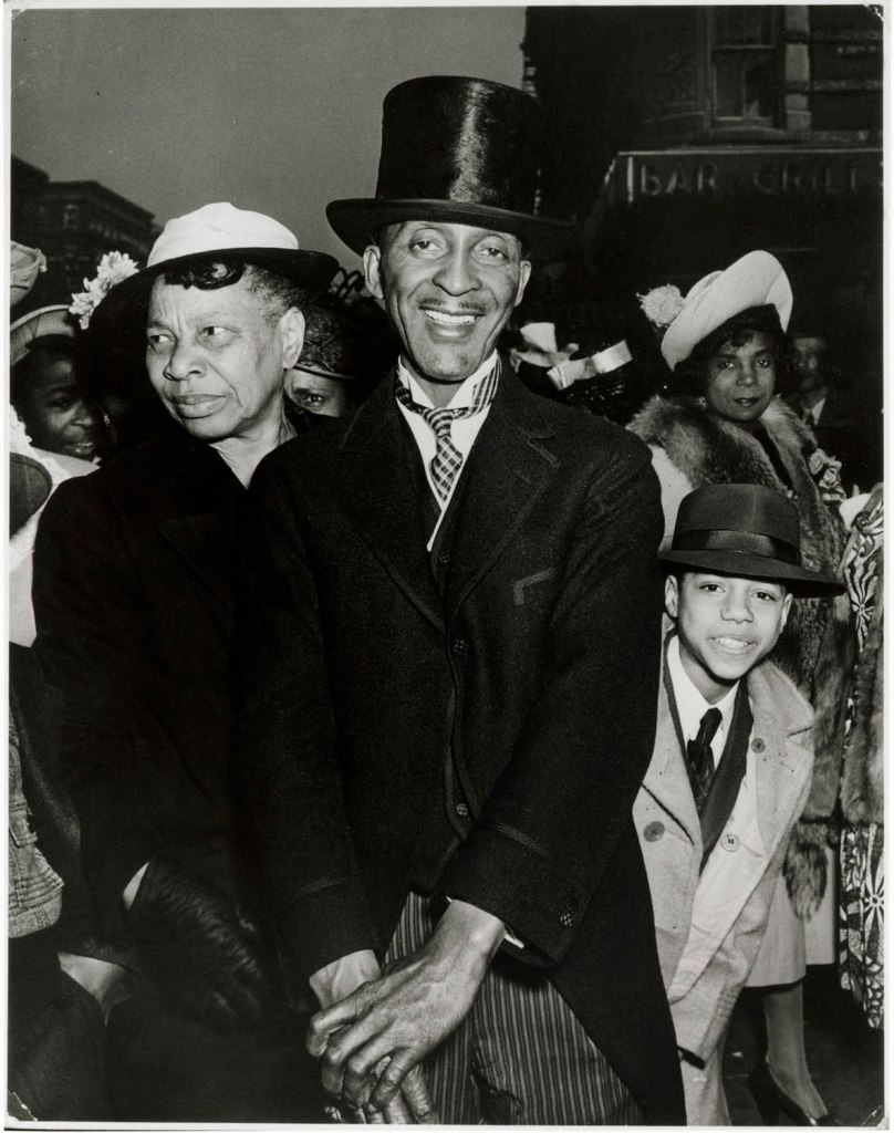 Weegee (Arthur Fellig) (American born Ukraine, 1899-1968) '[Clothing salesman, Easter Sunday, Harlem, New York]' c. 1940 from the exhibition 'Weegee: Society of the Spectacle' at the International Center of Photography, New York, Jan - May 2025
