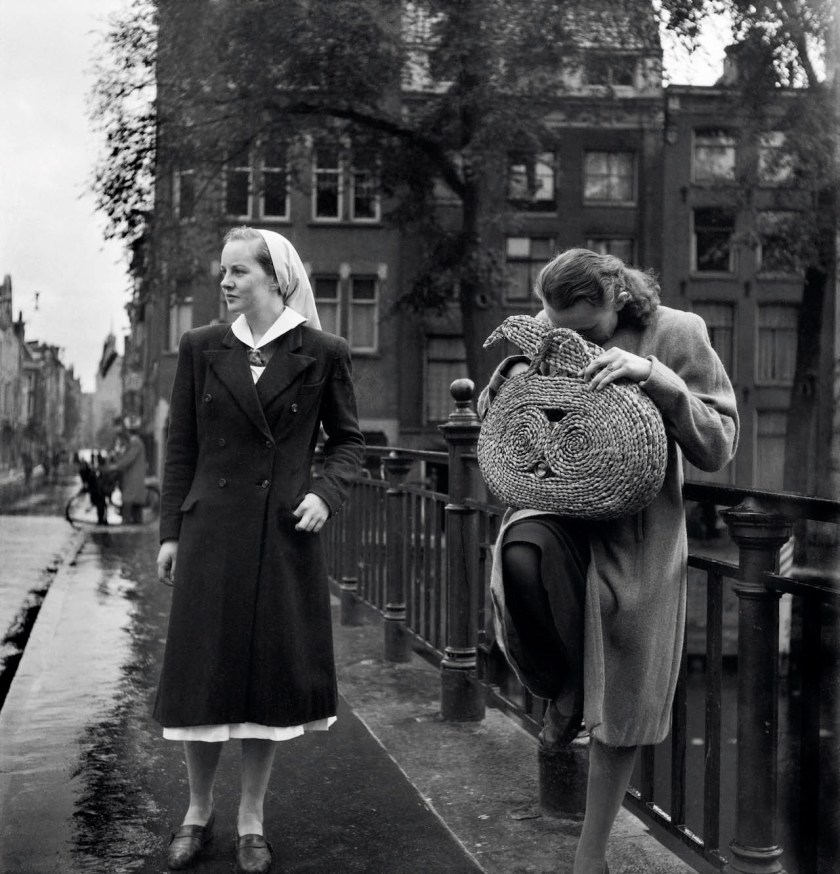 Charles Breijer (Dutch, 1914-2011) 'Andrea Domburg distracts bystanders while Margreet Meijboom-Van Konijnenburg takes the photo from her bag' Nd