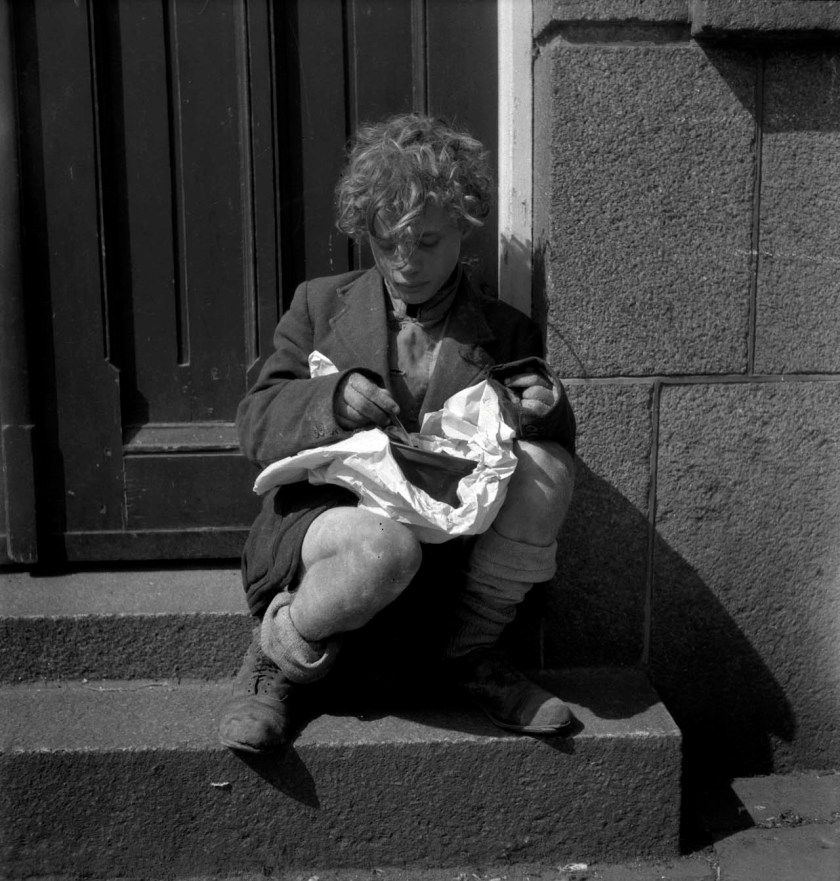 Emmy Andriesse (Dutch, 1914-1953) 'A boy eats a meal from a soup kitchen' Nd
